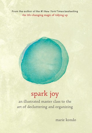 The book cover for 'Spark Joy: an illustrated master class to the art of decluttering and organising' by Marie Kondo, with a beige background and abstract green watercolour circle in the centre, and book title beneath